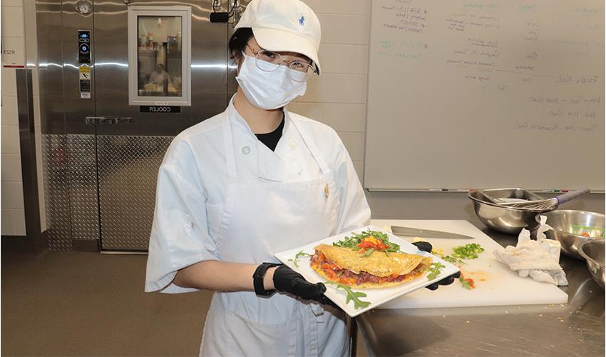 Culinary Arts student showing her culinary dish.
