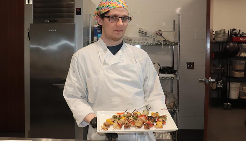 Culinary Arts student showing his culinary dish.